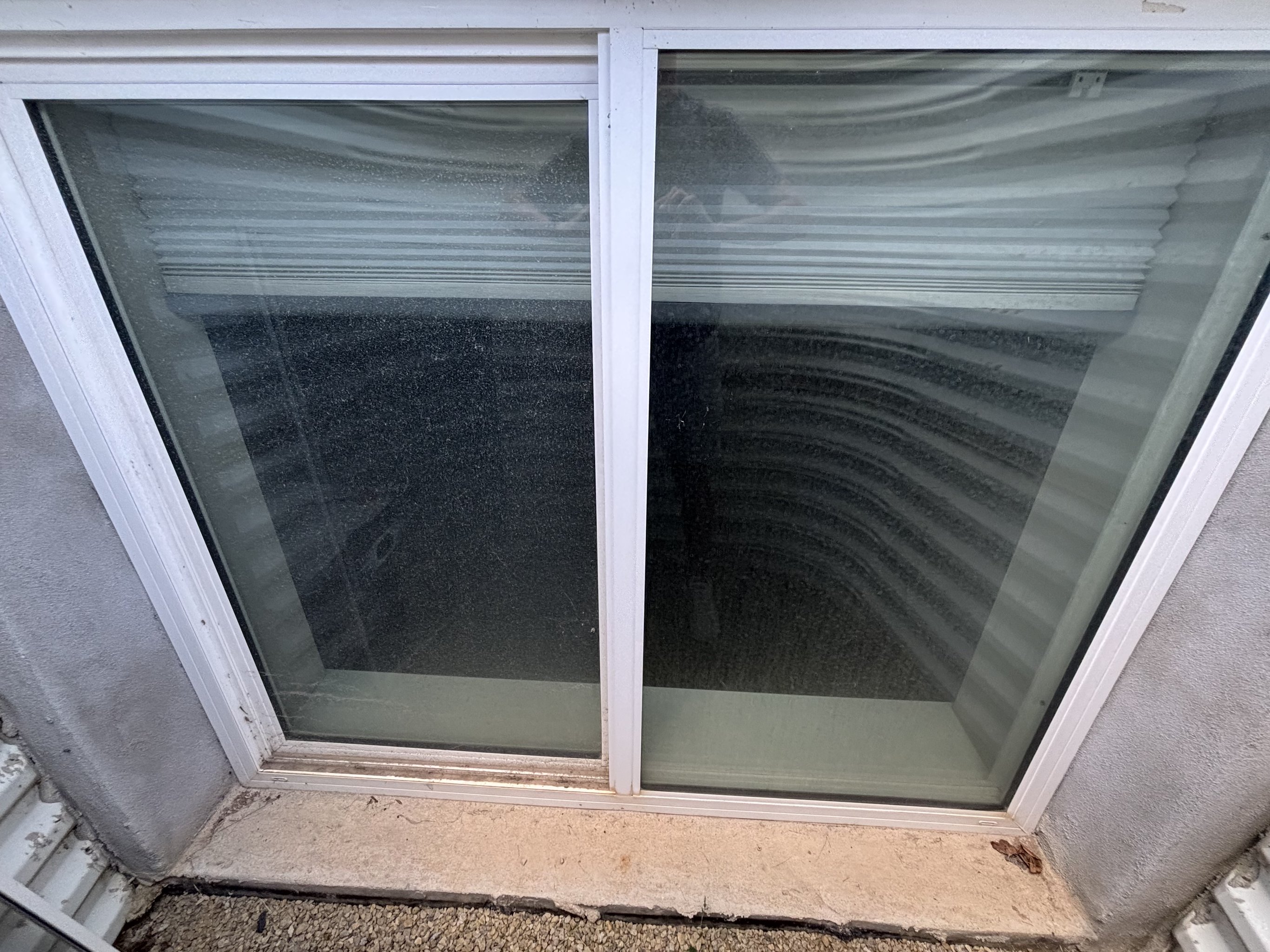 Ladder and squeegee at an exterior window